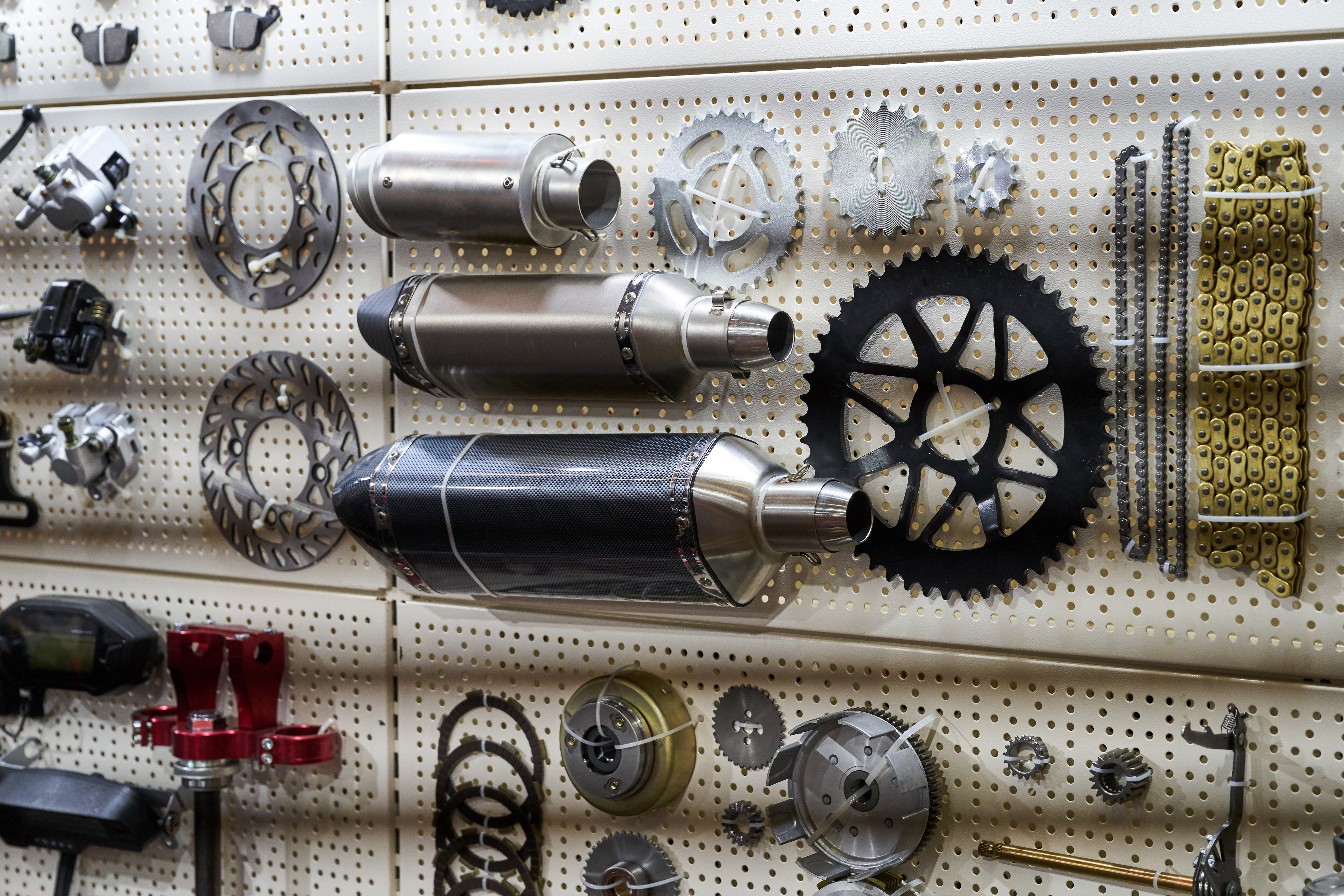 Motorcycle parts and accessories on the wall.